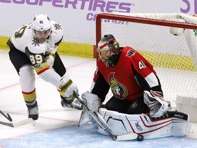 Golden Knights winger Alex Tuch shoves the puck past Senators goalie Craig Anderson to score in the first period of the first game of the season between the teams in Ottawa on Nov. 4.