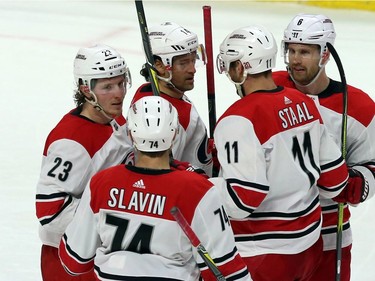 The Hurricanes' Brock McGinn (23) celebrates his second-period goal against the Senators with teammates Jaccob Slavin (74), Jordan Staal (11), Klas Dahlbeck (6) and Justin Williams (14).