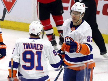 New York Islanders left wing Anders Lee (27) celebrates his goal against the Ottawa Senators with teammate John Tavares during first period NHL hockey in Ottawa, Tuesday, March 27, 2018 .