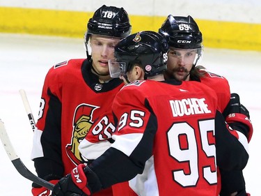 Ottawa Senators defenceman Erik Karlsson (65) celebrates his goal against the New York Islanders with Ryan Dzingel, left, and Matt Duchene during first period NHL hockey in Ottawa, Tuesday, March 27, 2018 .