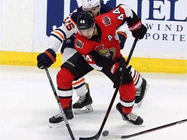 Edmonton Oilers defenceman Darnell Nurse (25) attempts to check Ottawa Senators centre Jean-Gabriel Pageau (44) during first period NHL hockey in Ottawa on Thursday, March 22, 2018.