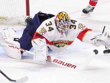 Florida Panthers goaltender James Reimer (34) gloves the puck while taking on the Ottawa Senators during the first period of NHL hockey action in Ottawa on Tuesday, March 20, 2018.