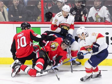 Ottawa Senators defenceman Mark Borowiecki (74) gets mixed up with left wing Tom Pyatt (10) and Florida Panthers left wing Jonathan Huberdeau (11) during the second period of NHL hockey action in Ottawa on Tuesday, March 20, 2018.