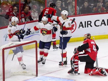 Florida Panthers centre Aleksander Barkov (16) right wing Evgenii Dadonov (63), and centre Nick Bjugstad (27) celebrate a goal against Ottawa Senators goaltender Craig Anderson (41) during the second period of NHL hockey action in Ottawa on Tuesday, March 20, 2018.