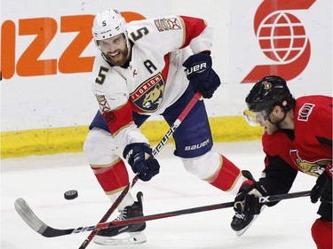 Florida Panthers defenceman Aaron Ekblad (5) shoots the puck past Ottawa Senators right wing Bobby Ryan (9) during second period NHL hockey action in Ottawa on Thursday, March 29, 2017.