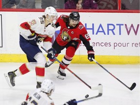 Senators defenceman Erik Karlsson tries to stop Panthers centre Henrik Borgstrom during first-period play in Thursday's game at Canadian Tire Centre.