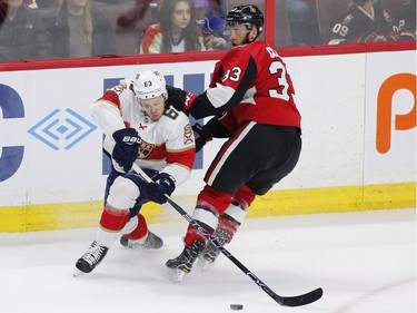 The Florida Panthers' Evgenii Dadonov tries to get past Ottawa Senators defenceman Fredrik Claesson.