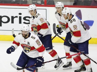 Florida Panthers defenceman Aaron Ekblad (5) celebrates his goal against the Ottawa Senators with centre Denis Malgin (62), centre Henrik Borgstrom (95), and left wing Jamie McGinn (88).