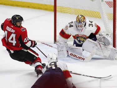 Ottawa Senators centre Jean-Gabriel Pageau is tripped by Florida Panthers defenceman Mike Matheson, resulting in a penalty shot, while goaltender James Reimer prepares to make a stop during overtime.