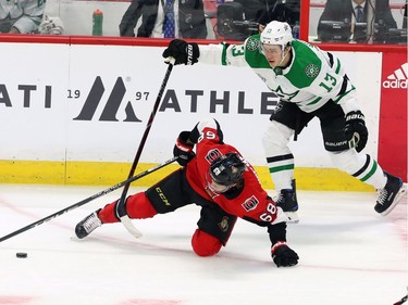 Senators winger Mike Hoffman (68) is tripped by the Stars' Mattias Janmark in the first period.