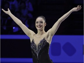 Kaetlyn Osmond of Canada celebrates after winning the women's world figure skating championship at Milan on Friday free skating program.