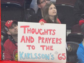 A young fans expresses her condolences as the Florida Panthers take on the Ottawa Senators during the second period of NHL hockey action in Ottawa on March 20, 2018