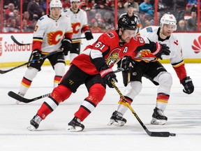 Mark Stone of the Ottawa Senators protects the puck from Matt Stajan of the Calgary Flames in the third period at Canadian Tire Centre on March 9, 2018 in Ottawa.  (Jana Chytilova/Freestyle Photography/Getty Images)