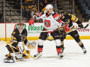 Ottawa 67’s winger Artur Tyanulin screens Hamilton Bulldogs goalie Kaden Fulcher while defenceman Justin Lemcke looks on last nightat First Ontario Centre in Hamilton.The Bulldogs overpowered the 67’s 6-3 to take Game 1 of their East quarterfinal.
(Brandon Taylor photo)