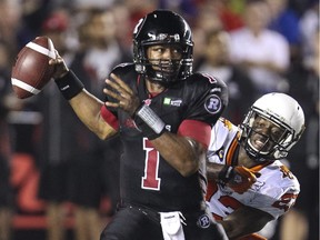 Josh Johnson works against Ottawa Redblacks QB Henry Burris while playing for the B.C. Lions in 2014.