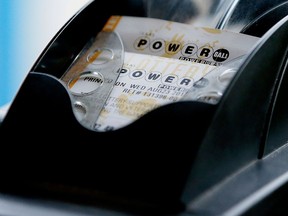 A Powerball lottery ticket is printed on a lottery machine at a convenience store in Dallas in a file photo. (AP Photo/LM Otero)