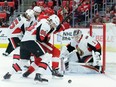 Senators defenseman Christian Wolanin (86) pushes Red Wings winger Darren Helm off the puck in front of goaltender Mike Condon during the second period.