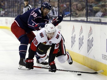 Blue Jackets forward Boone Jenner dumps the Senators' Matt Duchene along the boards, earning a minor penalty during the first period of Saturday's game.