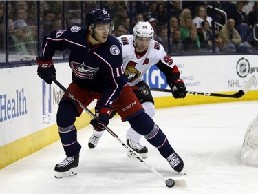 Blue Jackets forward Alexander Wennberg, left, controls the puck in front of Senators forward Matt Duchene during the first period.