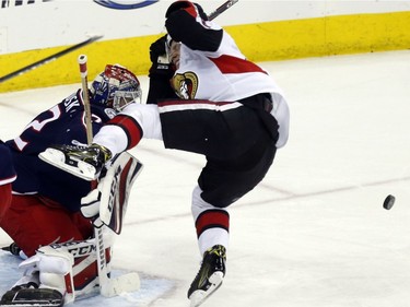 Senators forward Ryan Dzingel starts to fall after being hit on the back of the head by a shot from teammate Mike Hoffman in front of the Blue Jackets net in the third period.