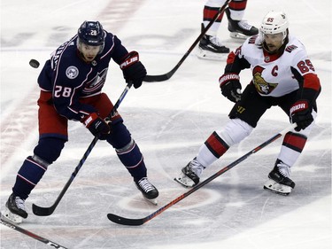 Columbus forward Oliver Bjorkstrand chases the puck against Ottawa captain Erik Karlsson, of Sweden during the third period.