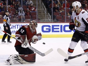 Arizona Coyotes goaltender Antti Raanta makes a save on a shot as Ottawa Senators left-winger Zack Smith looks on during the first period.