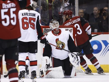 Senators netminder Mike Condon sags to his knees after giving up a goal to Coyotes defenceman Oliver Ekman-Larsson, right, during the first period.