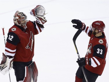 Coyotes netminder Antti Raanta exchanges high-fives with defenceman Alex Goligoski as time expires and Arizona records its 2-1 victory against Ottawa on Saturday night.