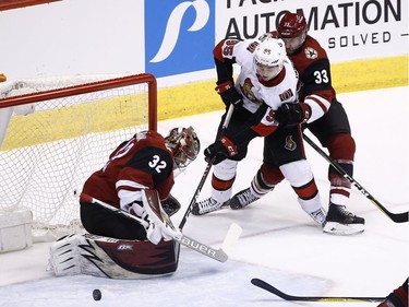 Senators centre Matt Duchene (95) is shoved by Coyotes defenceman Alex Goligoski as a shot gets blocked by goaltender Antti Raanta during the third period.