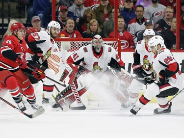 Carolina Hurricanes' Teuvo Teravainen (86), of Finland, and Valentin Zykov (73), of Russia, try to get a shot against Ottawa Senators goalie Craig Anderson (41) as Senators' Ben Harpur (67) and Ben Sexton (26) defend during the first period of an NHL hockey game in Raleigh, N.C., Monday, March 26, 2018.
