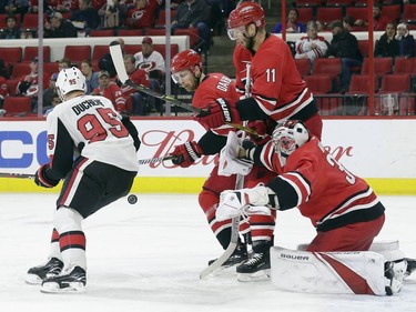 Carolina Hurricanes' Klas Dahlbeck, Jordan Staal (11) and goalie Cam Ward defend against Ottawa Senators' Matt Duchene (95) during the first period of an NHL hockey game in Raleigh, N.C., Monday, March 26, 2018.