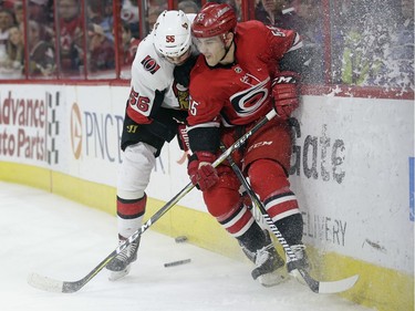 Ottawa Senators' Magnus Paajarvi (56), of Sweden, and Carolina Hurricanes' Roland McKeown (55) chase the puck during the first period of an NHL hockey game in Raleigh, N.C., Monday, March 26, 2018.