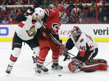 Carolina Hurricanes' Warren Foegele (37) tries to score against Ottawa Senators goalie Craig Anderson (41) while Senators' Thomas Chabot defends during the second period of an NHL hockey game in Raleigh, N.C., Monday, March 26, 2018.