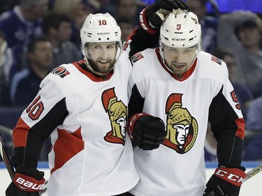 Ottawa Senators left wing Tom Pyatt (10) celebrates his goal against the Tampa Bay Lightning with defenseman Cody Ceci (5) during the first period of an NHL hockey game Tuesday, March 13, 2018, in Tampa, Fla.