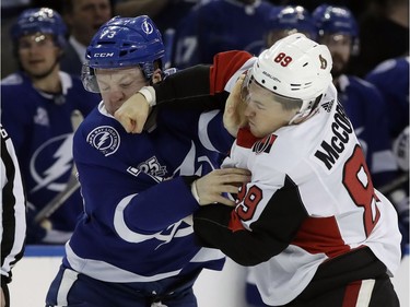 Ottawa Senators left wing Max McCormick (89) connects with a punch as he fights Tampa Bay Lightning left wing Adam Erne (73) during the first period of an NHL hockey game Tuesday, March 13, 2018, in Tampa, Fla.