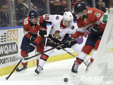 Florida Panthers' Jared McCann (90) and Aaron Ekblad (5) go for the puck against Ottawa Senators' Ryan Dzingel (18) during the second period of an NHL hockey game, Monday, March 12, 2018, in Sunrise, Fla.