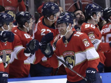 Florida Panthers' Mike Matheson (19) is congratulated after scoring a goal during the second period of an NHL hockey game against the Ottawa Senators, Monday, March 12, 2018, in Sunrise, Fla.