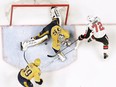 Senators defenceman Thomas Chabot forces Predators goalie Pekka Rinne into making a tough save during a game at Nashville last Monday.