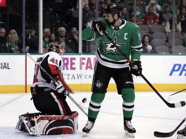 Ottawa Senators goalie Craig Anderson (41) blocks a shot from the Dallas Stars as left wing Jamie Benn (14) pressures the net in the first period of an NHL hockey game in Dallas, Monday, March 5, 2018.