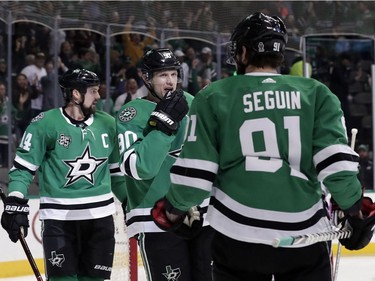 Dallas Stars left wing Jamie Benn (14), and center Jason Spezza (90) congratulate Tyler Seguin (91) on his goal in the first period of an NHL hockey game against the Ottawa Senators in Dallas, Monday, March 5, 2018.