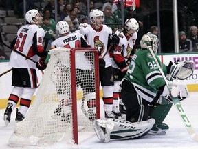 Dallas Stars goalie Kari Lehtonen (32), of Finland, kneels in front of the net as Ottawa Senators' Mark Stone (61), Jean-Gabriel Pageau (44), Matt Duchene and Erik Karlsson, right rear, celebrate a goal scored by Mike Hoffman (not shown) in the second period of an NHL hockey game in Dallas, Monday, March 5, 2018.