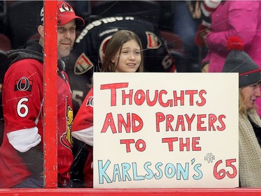 At least one youngster was feeling for defenceman Erik Karlsson and his wife Melinda who loss their baby as the Ottawa Senators take on the Florida Panthers in NHL action at the Canadian Tire Centre in Ottawa.  Photo by Wayne Cuddington/ Postmedia