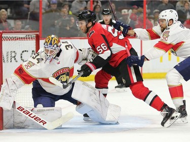Magnus Paajarvi is pushed into the net and goalie James Reimer by Aaron Ekblad in the first period as the Ottawa Senators take on the Florida Panthers in NHL action at the Canadian Tire Centre in Ottawa.  Photo by Wayne Cuddington/ Postmedia