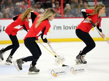 Women clean the ice during a stoppage in play in the first period as the Ottawa Senators take on the Florida Panthers in NHL action at the Canadian Tire Centre in Ottawa.  Photo by Wayne Cuddington/ Postmedia
