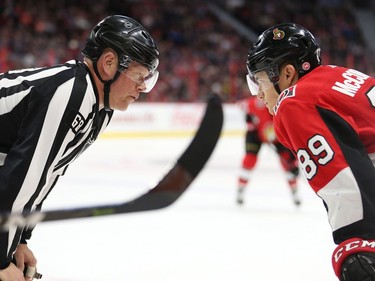 Linesman Scott Driscoll stares down Max McCormick after he tossed him out of the face-off and Max had an opinion on the matter in the first period as the Ottawa Senators take on the Edmonton Oilers in NHL action at the Canadian Tire Centre in Ottawa.