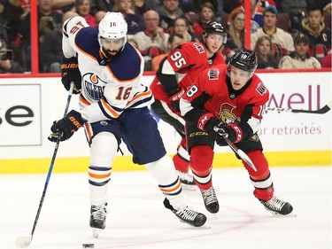 Jujhar Khaira (L) skates away from Ryan Dzingel with Matt Duchene looking on in the first period as the Ottawa Senators take on the Edmonton Oilers in NHL action at the Canadian Tire Centre in Ottawa.