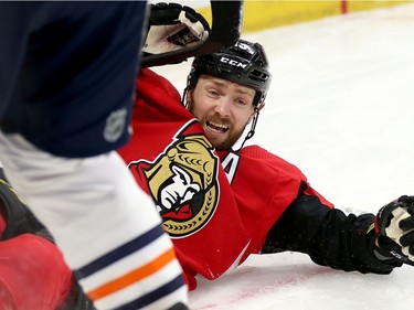 Zack Smith reacts to being pushed into the end boards by Darnell Nurse in the first period as the Ottawa Senators take on the Edmonton Oilers in NHL action at the Canadian Tire Centre in Ottawa.