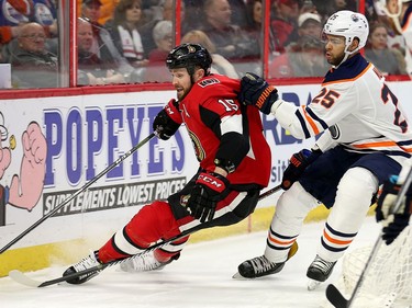 Zack Smith is pushed into the end boards by Darnell Nurse in the first period as the Ottawa Senators take on the Edmonton Oilers in NHL action at the Canadian Tire Centre in Ottawa.