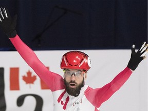 Charles Hamelin celebrates after winning the 1,500-metre final race of the ISU world short-track speed skating championships in Montreal on Saturday.