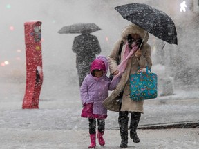 Pedestrians walk along Delancey St. during a snowstorm, Wednesday, March 7, 2018, in New York. (AP Photo/Mary Altaffer)